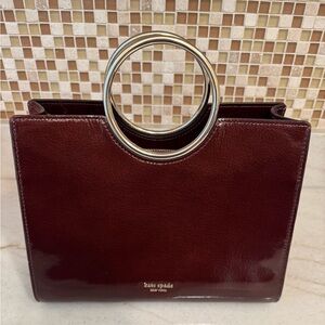 NWOT KATE SPADE Sam Bracelet
Bag in BURGUNDY patent leather